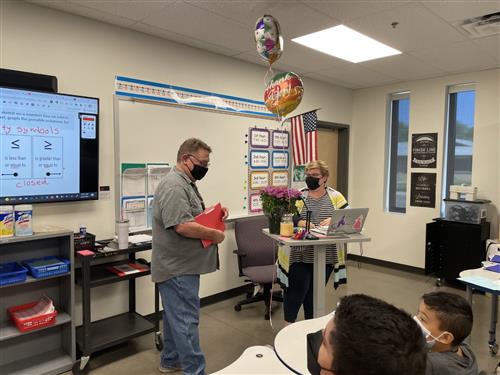 Mrs. Robertson is presented her awawrd
