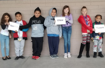  A group of students hold a sign