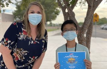  Principal carr and nathan holding a certificate