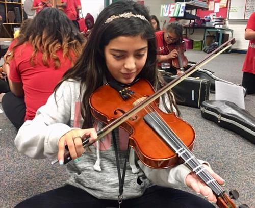 a student practicies the violin