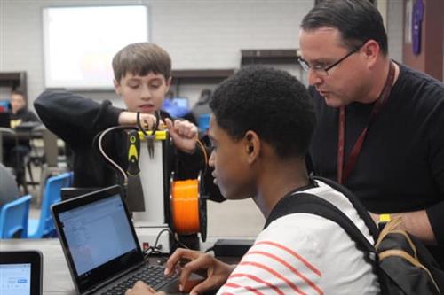 students work on a science experiment