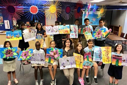 students holding art