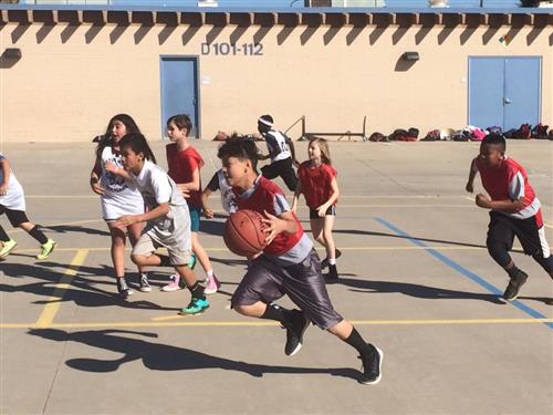 Students playing basketball outside
