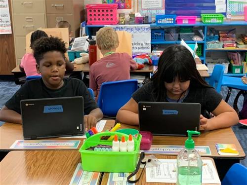 students working on chromebook computers
