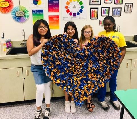 students hold a group art project