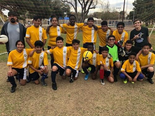 a boys soccer team in yellow jerseys