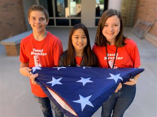 students hold a flag for veterans day