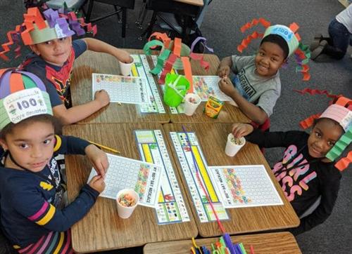 students wear handmade hats