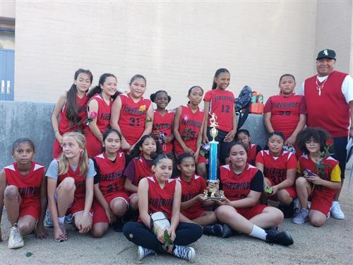 the girls basketball team poses for a picutre