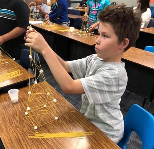 a student builds a sculpture