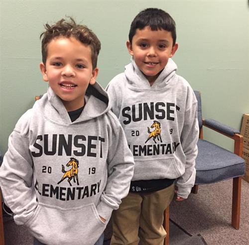 students wear sunset sweaters