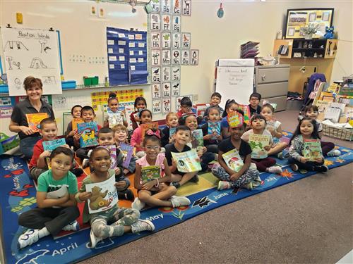 students show off books