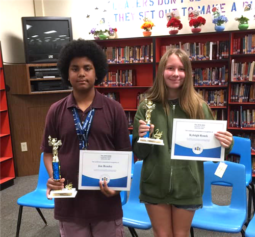 students show off spelling bee trophies