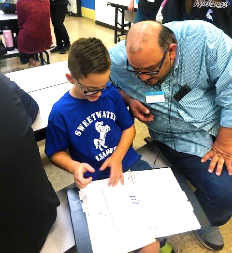 a father and son work together