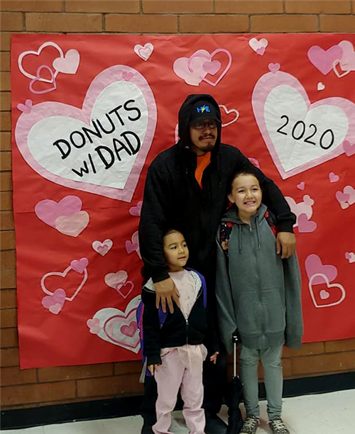 a father and daughters attend an event