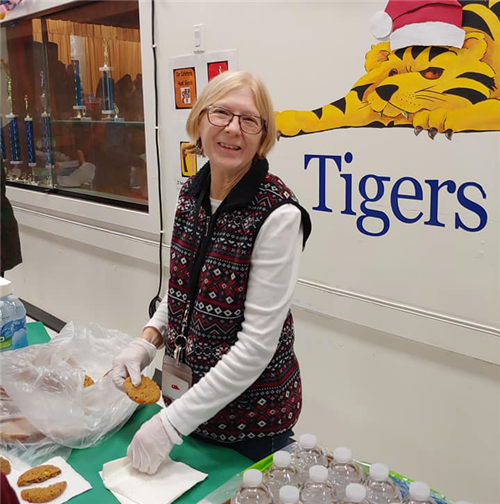 a volunteer hands out cookies