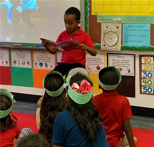 a student reads to his classmates
